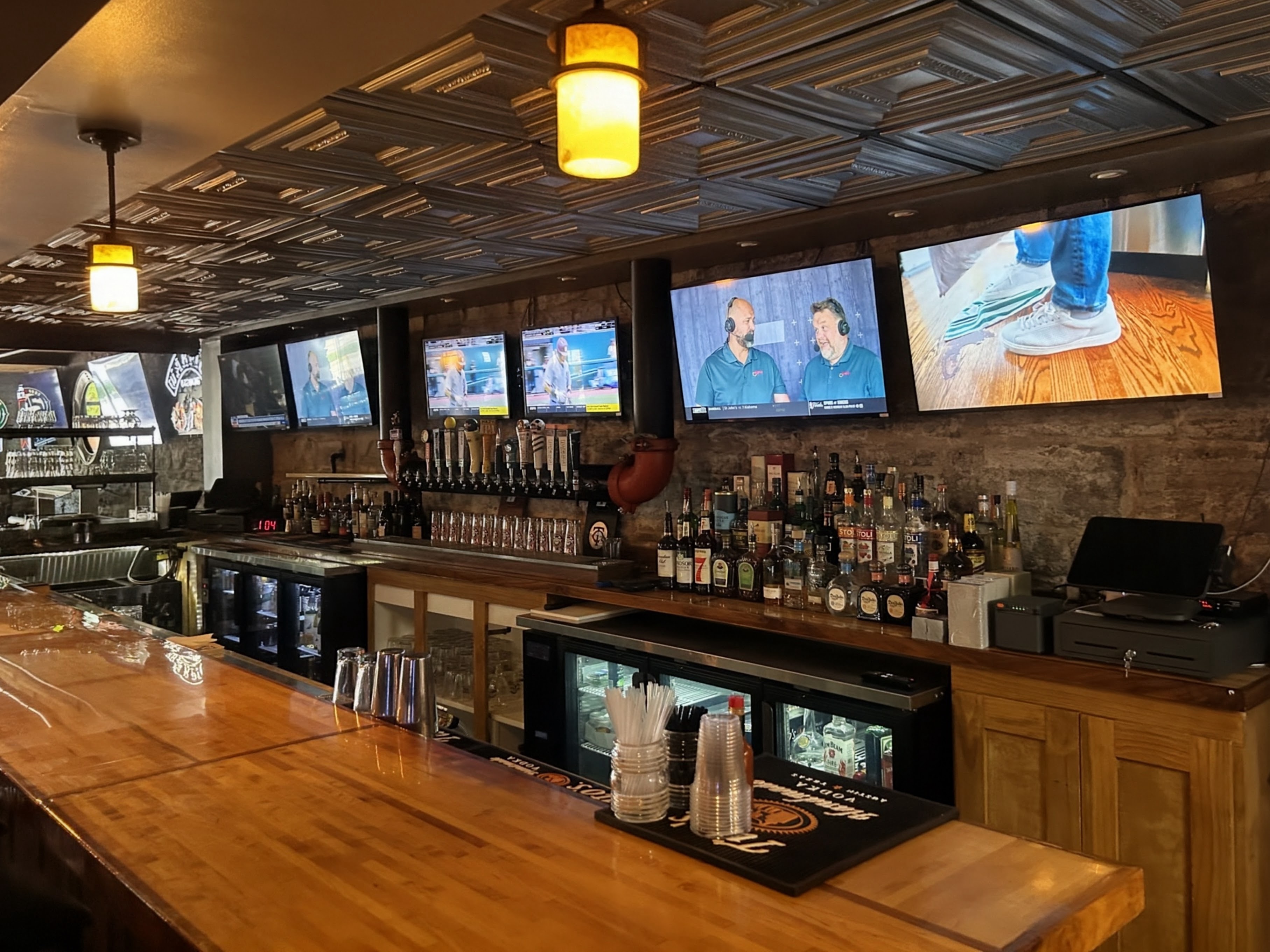 Inside Fathead Bill's Sports Pub & Grill -- polished bar, craft taps, and wall-to-wall screens